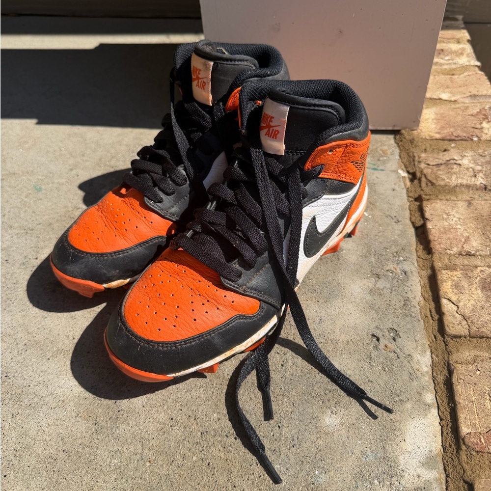 Jordan’s 1 football  or baseball cleats orange and black